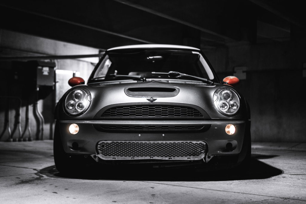 Dramatic dark lit photo of a Mini car showing Sandfield Engineering ties with the Automotive industry