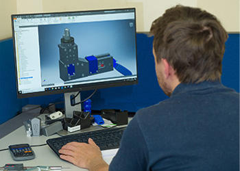 Man working of CAD design software on a computer from Sandfield Engineering