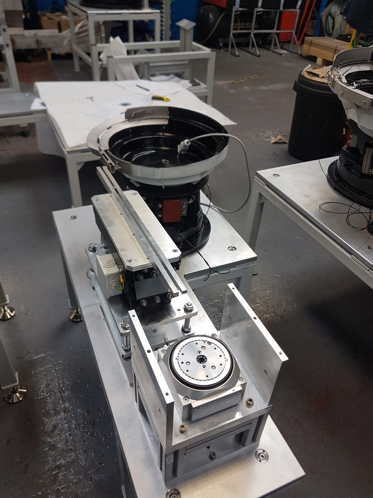 A full view of a Sandfield Engineering vibratory bowl feeding line.