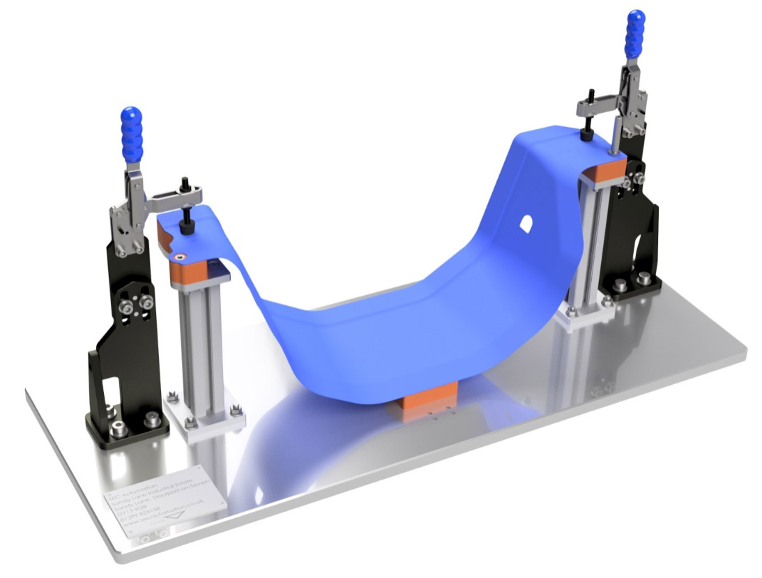 A base plat with two toggle clamps attached with fabric draped between them, showing Sandfield engineering product in use.